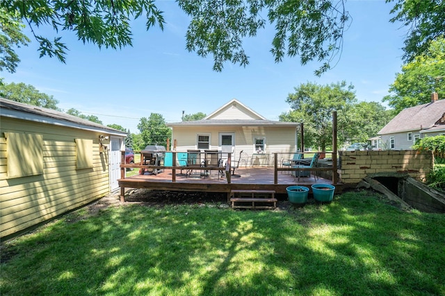 808 Bridge St, Redfield, IA 50233 - rear view of house with a wooden deck, a lawn, and outdoor dining area