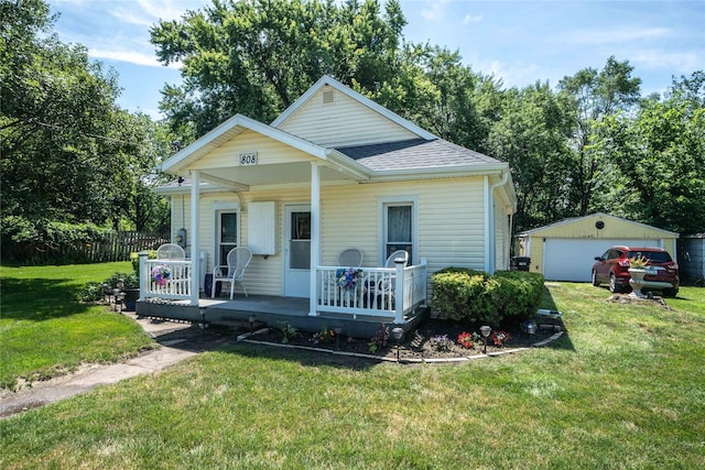 808 Bridge St, Redfield, IA 50233 - bungalow with an outdoor structure, a detached garage, a shingled roof, and covered porch