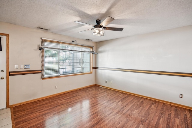 1517 SE Delaware Ave Unit 2, Ankeny, IA 50021 - spare room featuring a textured ceiling, a ceiling fan, and wood finished floors