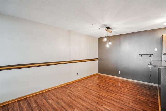 1517 SE Delaware Ave Unit 2, Ankeny, IA 50021 - unfurnished room featuring wood finished floors and a textured ceiling