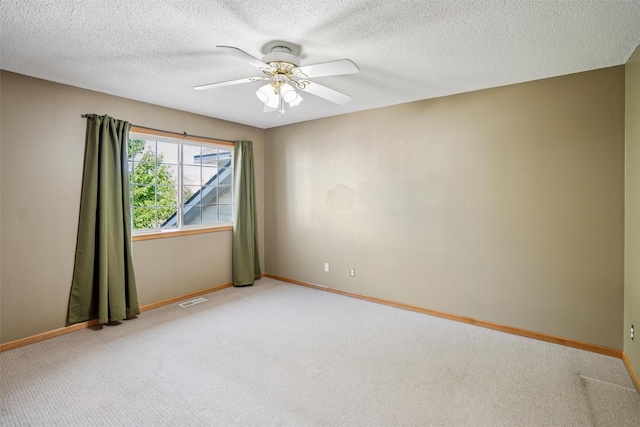 1517 SE Delaware Ave Unit 2, Ankeny, IA 50021 - empty room featuring light carpet, a ceiling fan, and a textured ceiling