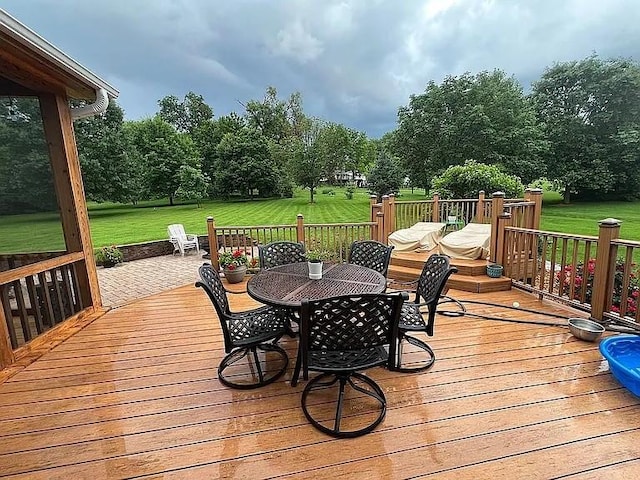 2279 Pheasant Ridge Ln, Ames, IA 50010 - wooden deck featuring outdoor dining area and a lawn