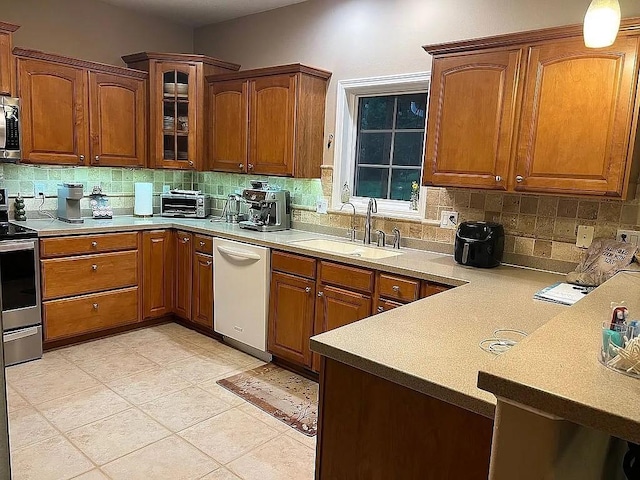 2279 Pheasant Ridge Ln, Ames, IA 50010 - kitchen featuring stainless steel appliances, decorative backsplash, glass insert cabinets, and light countertops