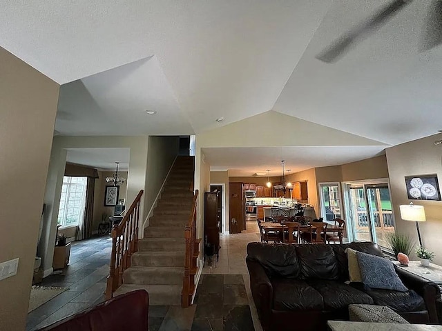 2279 Pheasant Ridge Ln, Ames, IA 50010 - living room with a chandelier, stairway, lofted ceiling, and stone tile flooring