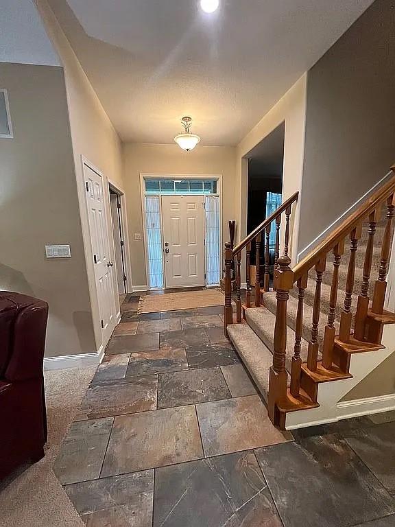 2279 Pheasant Ridge Ln, Ames, IA 50010 - foyer with stairway and stone tile floors