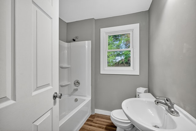 34 E Broadway St, Colfax, IA 50054 - bathroom featuring shower / washtub combination and wood finished floors
