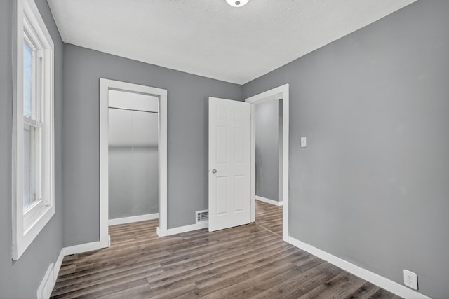 34 E Broadway St, Colfax, IA 50054 - unfurnished bedroom featuring a closet and wood finished floors