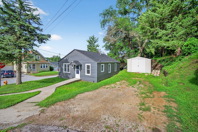 34 E Broadway St, Colfax, IA 50054 - bungalow-style home with a shed and a front yard