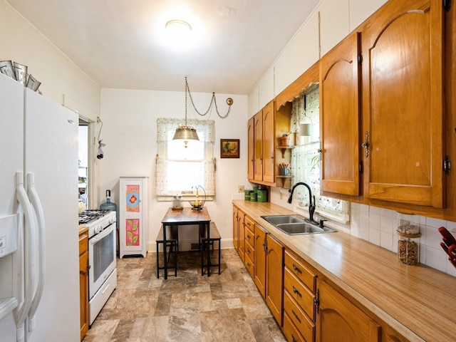 3917 11th St, Des Moines, IA 50313 - kitchen with white appliances, light countertops, brown cabinets, decorative backsplash, and stone finish floors