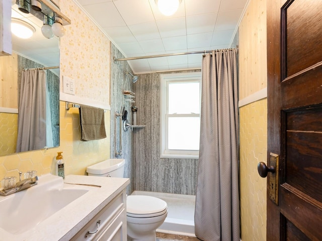 3917 11th St, Des Moines, IA 50313 - bathroom featuring a shower stall, vanity, wallpapered walls, crown molding, and wainscoting