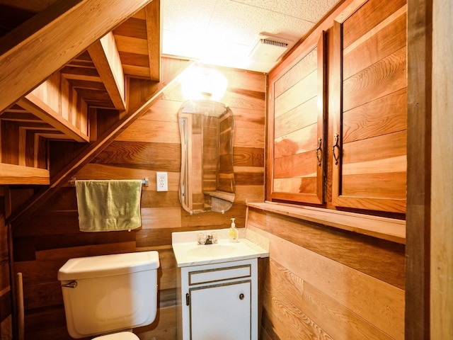 3917 11th St, Des Moines, IA 50313 - half bathroom featuring wood walls and vanity