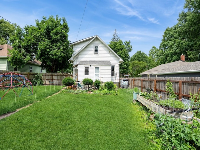 3917 11th St, Des Moines, IA 50313 - rear view of house featuring a garden and a fenced backyard