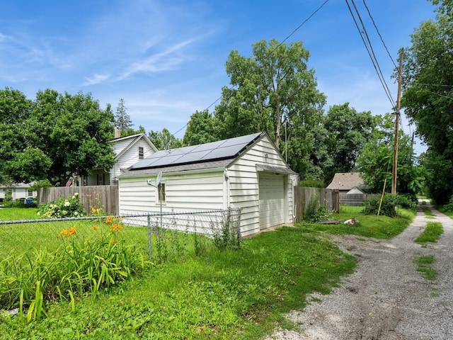 3917 11th St, Des Moines, IA 50313 - view of outbuilding with solar panels and driveway