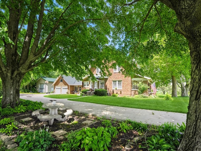 4987 E 28th St N, Newton, IA 50208 - view of property hidden behind natural elements with driveway, brick siding, a front yard, and a garage