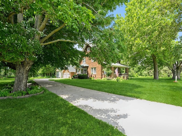 4987 E 28th St N, Newton, IA 50208 - obstructed view of property with a front lawn, driveway, and brick siding