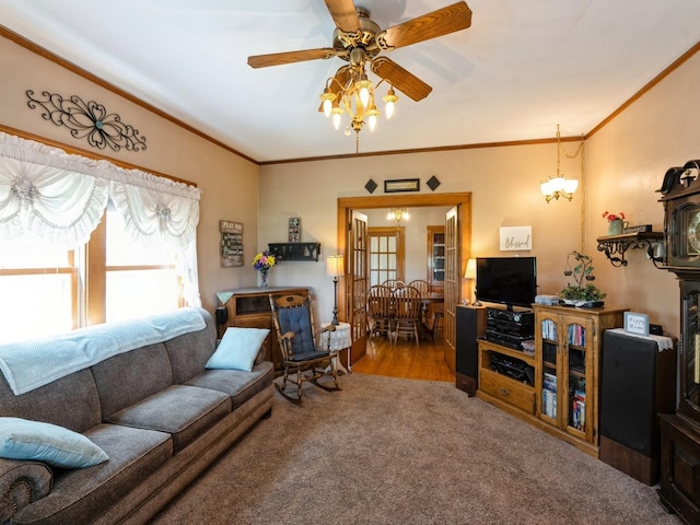 4987 E 28th St N, Newton, IA 50208 - carpeted living room with a chandelier, ceiling fan, and ornamental molding