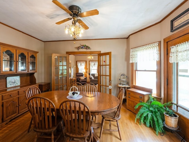 4987 E 28th St N, Newton, IA 50208 - dining space featuring light wood-type flooring, french doors, crown molding, and a ceiling fan