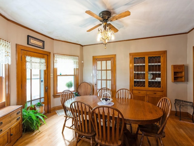 4987 E 28th St N, Newton, IA 50208 - dining space with light wood-type flooring, a ceiling fan, and ornamental molding