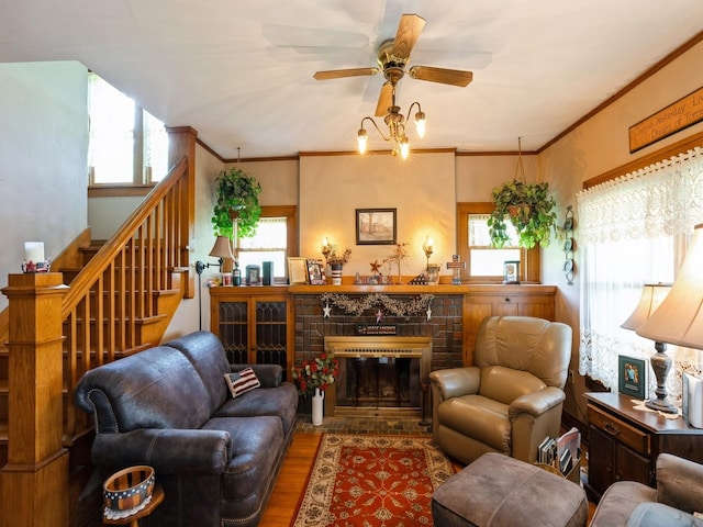 4987 E 28th St N, Newton, IA 50208 - living area featuring wood finished floors, healthy amount of natural light, stairway, and crown molding