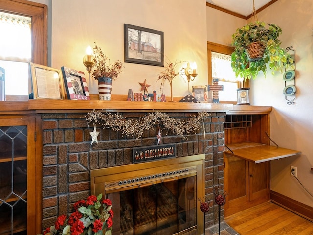 4987 E 28th St N, Newton, IA 50208 - bar with a brick fireplace, wood finished floors, healthy amount of natural light, and ornamental molding