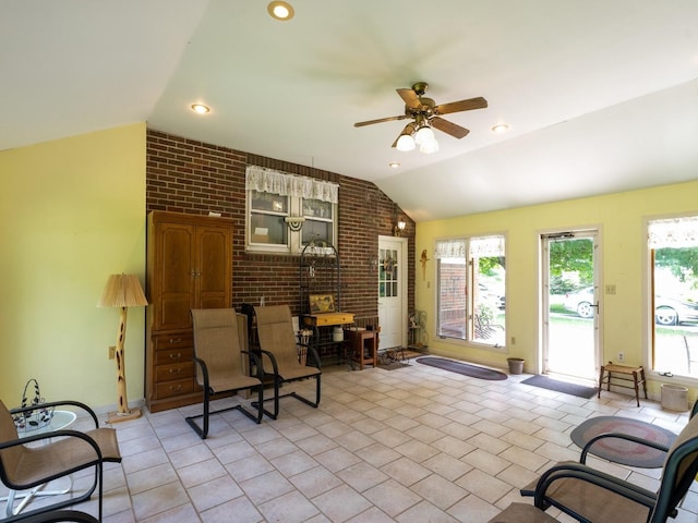 4987 E 28th St N, Newton, IA 50208 - living area featuring lofted ceiling, brick wall, a ceiling fan, and recessed lighting