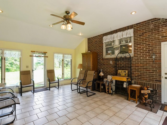 4987 E 28th St N, Newton, IA 50208 - living area with vaulted ceiling, brick wall, ceiling fan, light tile patterned flooring, and recessed lighting