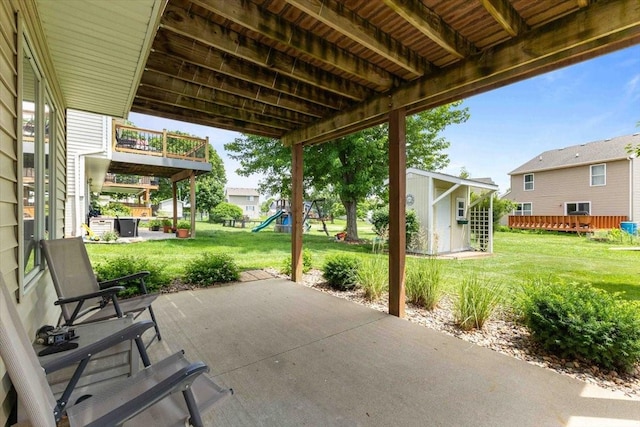 827 SW 46th St, Ankeny, IA 50023 - view of patio with a playground and a storage unit