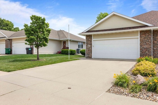 827 SW 46th St, Ankeny, IA 50023 - ranch-style house with a front lawn, concrete driveway, stone siding, and an attached garage
