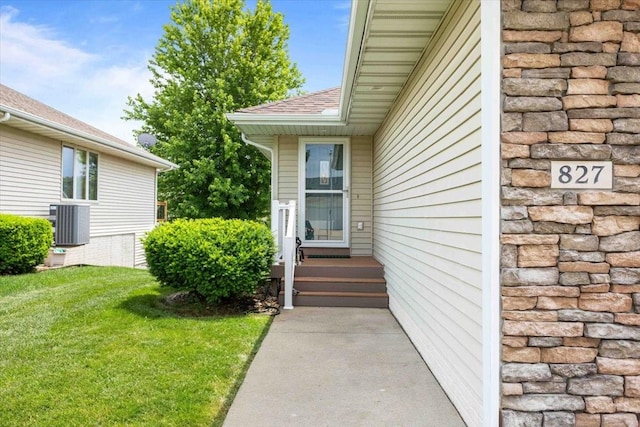 827 SW 46th St, Ankeny, IA 50023 - view of exterior entry with a shingled roof and a lawn