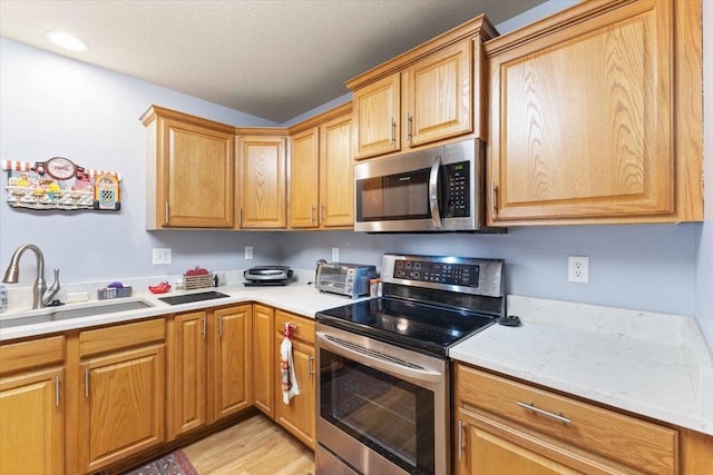 827 SW 46th St, Ankeny, IA 50023 - kitchen with appliances with stainless steel finishes, light countertops, and light wood-style floors