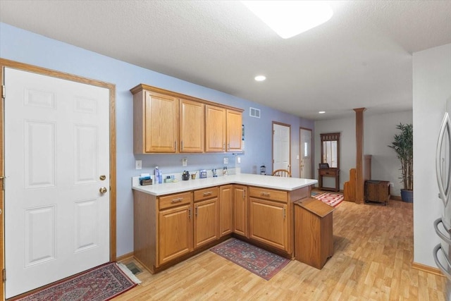 827 SW 46th St, Ankeny, IA 50023 - kitchen featuring a peninsula, light wood-style flooring, light countertops, and recessed lighting