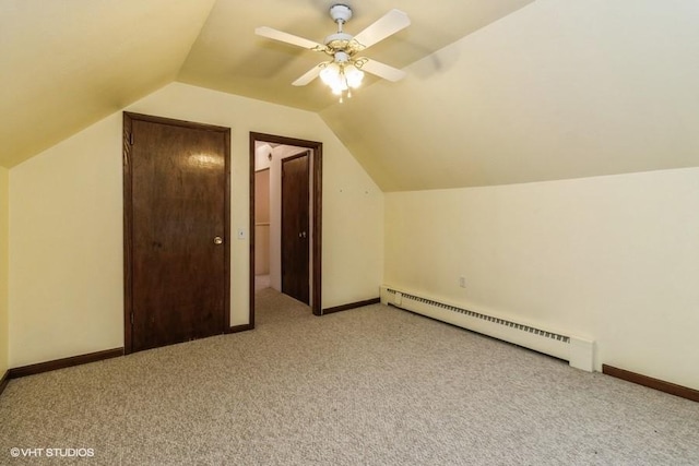 644 N 43rd St, Cumming, IA 50061 - bonus room featuring a baseboard radiator, light carpet, lofted ceiling, and a ceiling fan