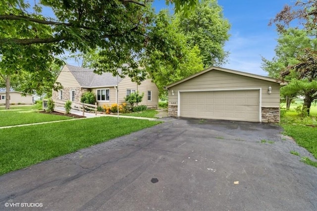 644 N 43rd St, Cumming, IA 50061 - ranch-style home featuring stone siding, a detached garage, a front lawn, and an outdoor structure