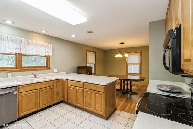 644 N 43rd St, Cumming, IA 50061 - kitchen with electric range, stainless steel dishwasher, black microwave, a peninsula, and light tile patterned flooring