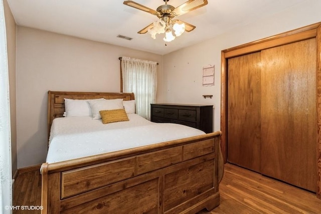 644 N 43rd St, Cumming, IA 50061 - bedroom with wood finished floors, a closet, and ceiling fan