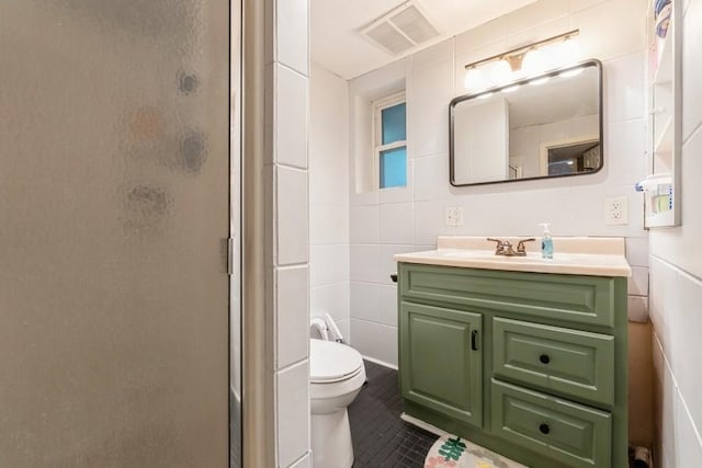 1525 Rapids St, Adel, IA 50003 - bathroom with a stall shower, vanity, tile walls, and tile patterned floors