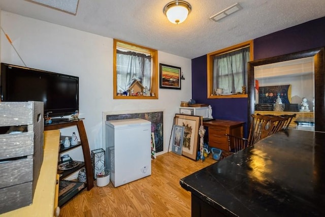 1525 Rapids St, Adel, IA 50003 - home office with wood finished floors and a textured ceiling