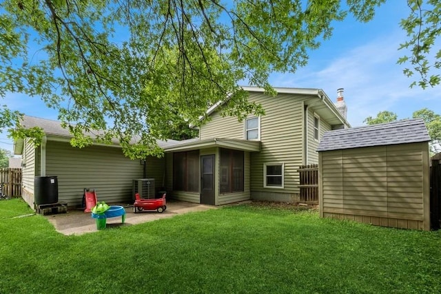 1525 Rapids St, Adel, IA 50003 - rear view of house featuring a patio area, a storage unit, a sunroom, and a chimney