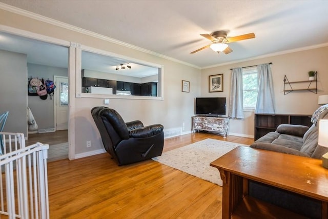 1525 Rapids St, Adel, IA 50003 - living room with light wood-style floors, a ceiling fan, and ornamental molding