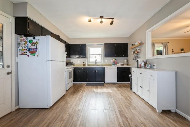 1525 Rapids St, Adel, IA 50003 - kitchen featuring white appliances, light wood-style flooring, dark cabinets, and light countertops