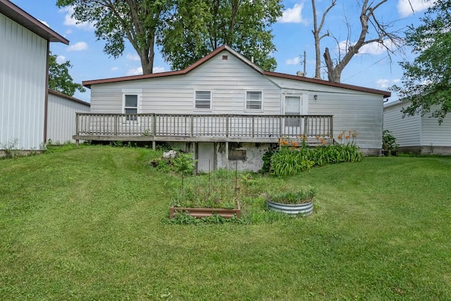 1107 E 12th St N, Newton, IA 50208 - rear view of property with a wooden deck, a garden, and a lawn