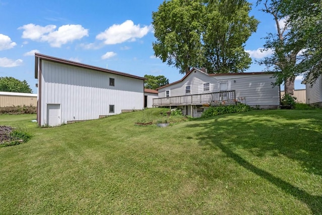 1107 E 12th St N, Newton, IA 50208 - rear view of house featuring a wooden deck and a lawn