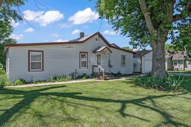 1107 E 12th St N, Newton, IA 50208 - rear view of property with a lawn and a chimney