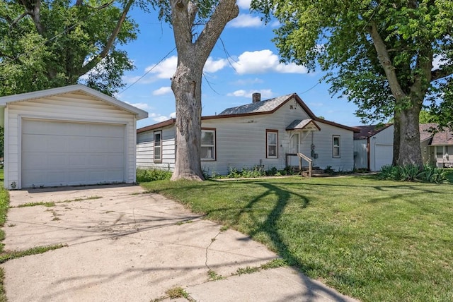 1107 E 12th St N, Newton, IA 50208 - view of front of property featuring driveway, a front yard, a chimney, an outbuilding, and a garage