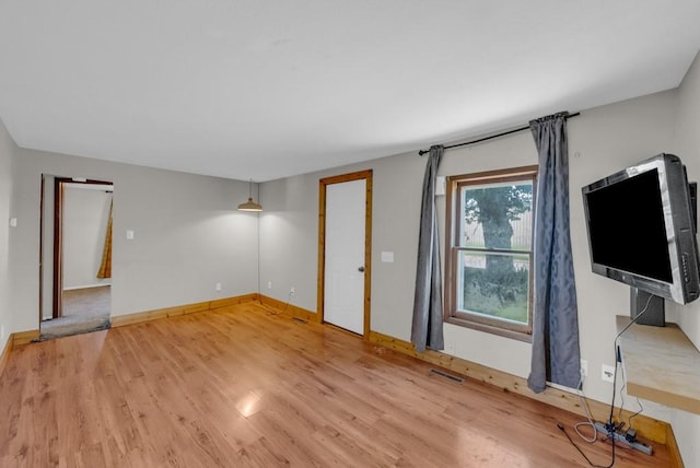 1107 E 12th St N, Newton, IA 50208 - unfurnished living room with light wood-style floors