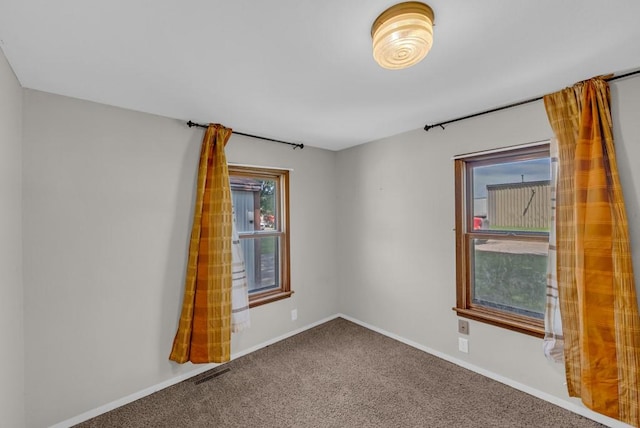 1107 E 12th St N, Newton, IA 50208 - carpeted spare room featuring baseboards