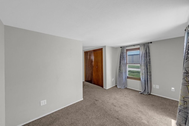 1107 E 12th St N, Newton, IA 50208 - carpeted empty room with baseboards