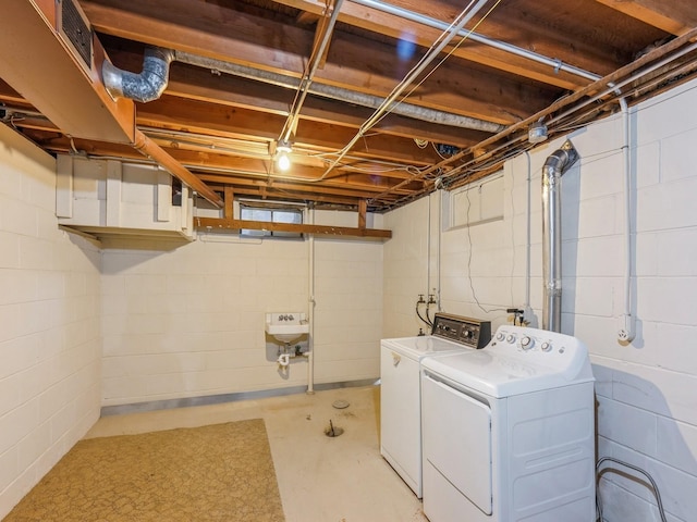 4041 Columbia St, Des Moines, IA 50313 - laundry area with washer and clothes dryer and concrete block wall