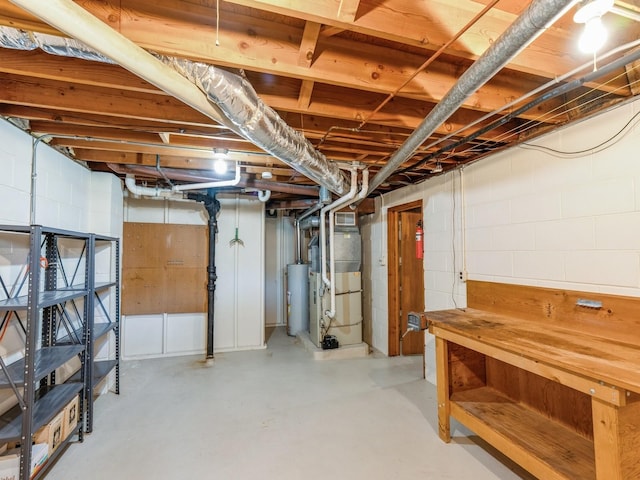 4041 Columbia St, Des Moines, IA 50313 - unfinished below grade area featuring gas water heater, concrete block wall, and heating unit