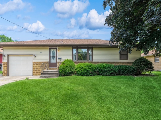 4041 Columbia St, Des Moines, IA 50313 - ranch-style house featuring brick siding, a garage, a front yard, and concrete driveway